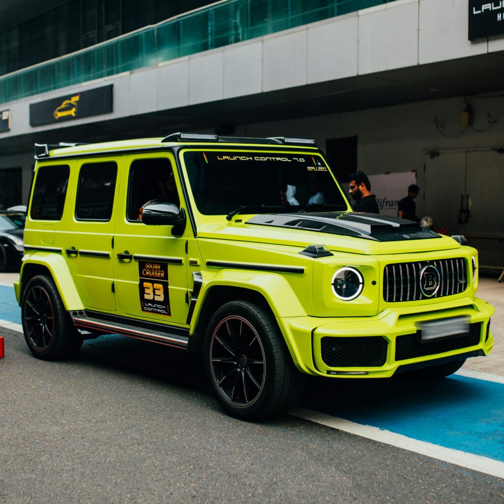 Vibrant lime green SUV displayed at an auto exhibition in Greater Noida, India.